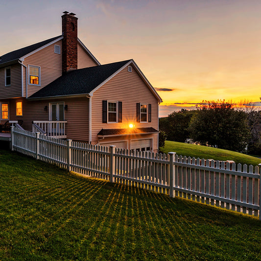 House with a fence and a sloped yard